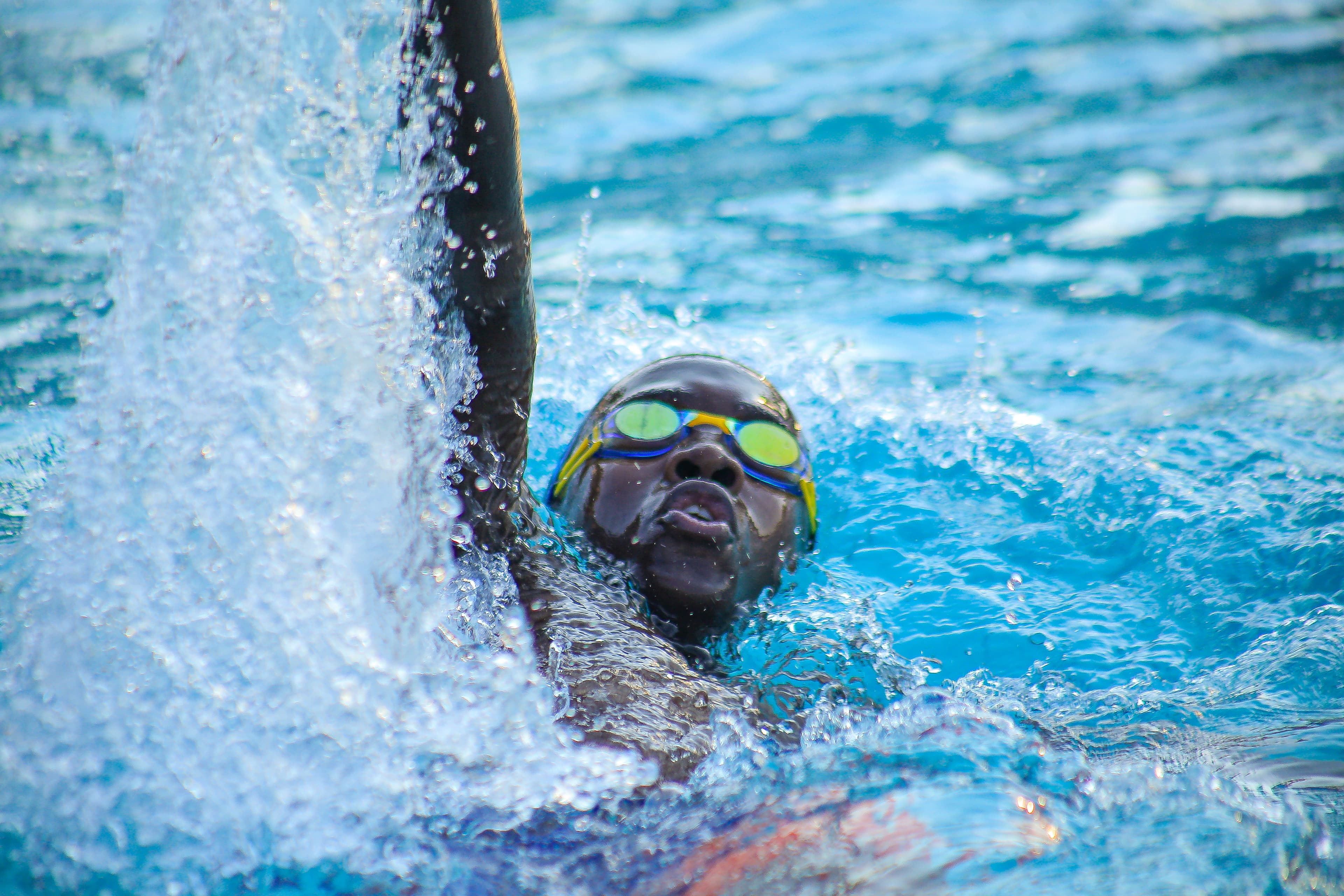 An Imara swimmer racing backstroke