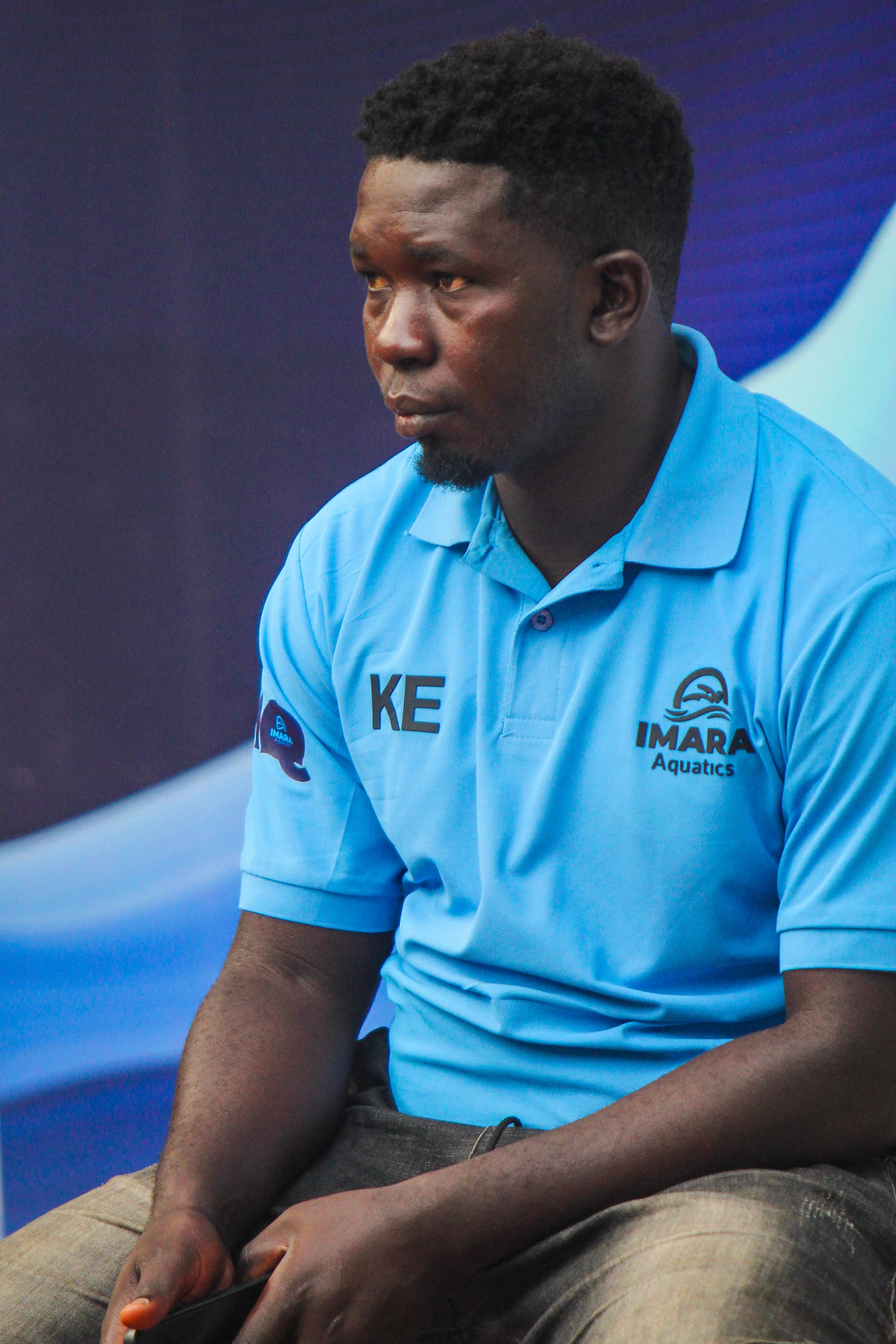 Ezra Kalali wearing an Imara Aquatics coaching shirt