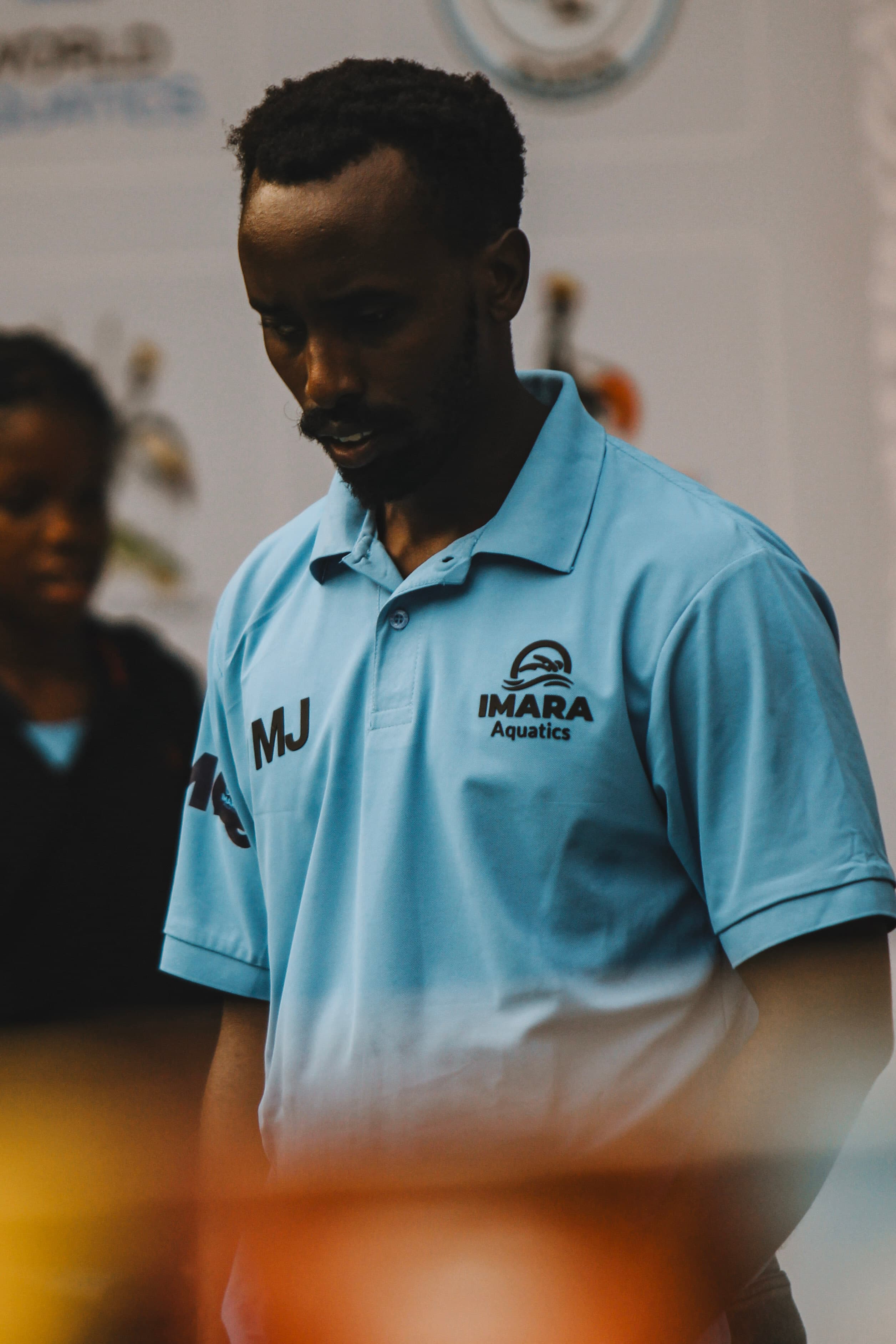 Jacob Mugisha wearing an Imara Aquatics coaching shirt