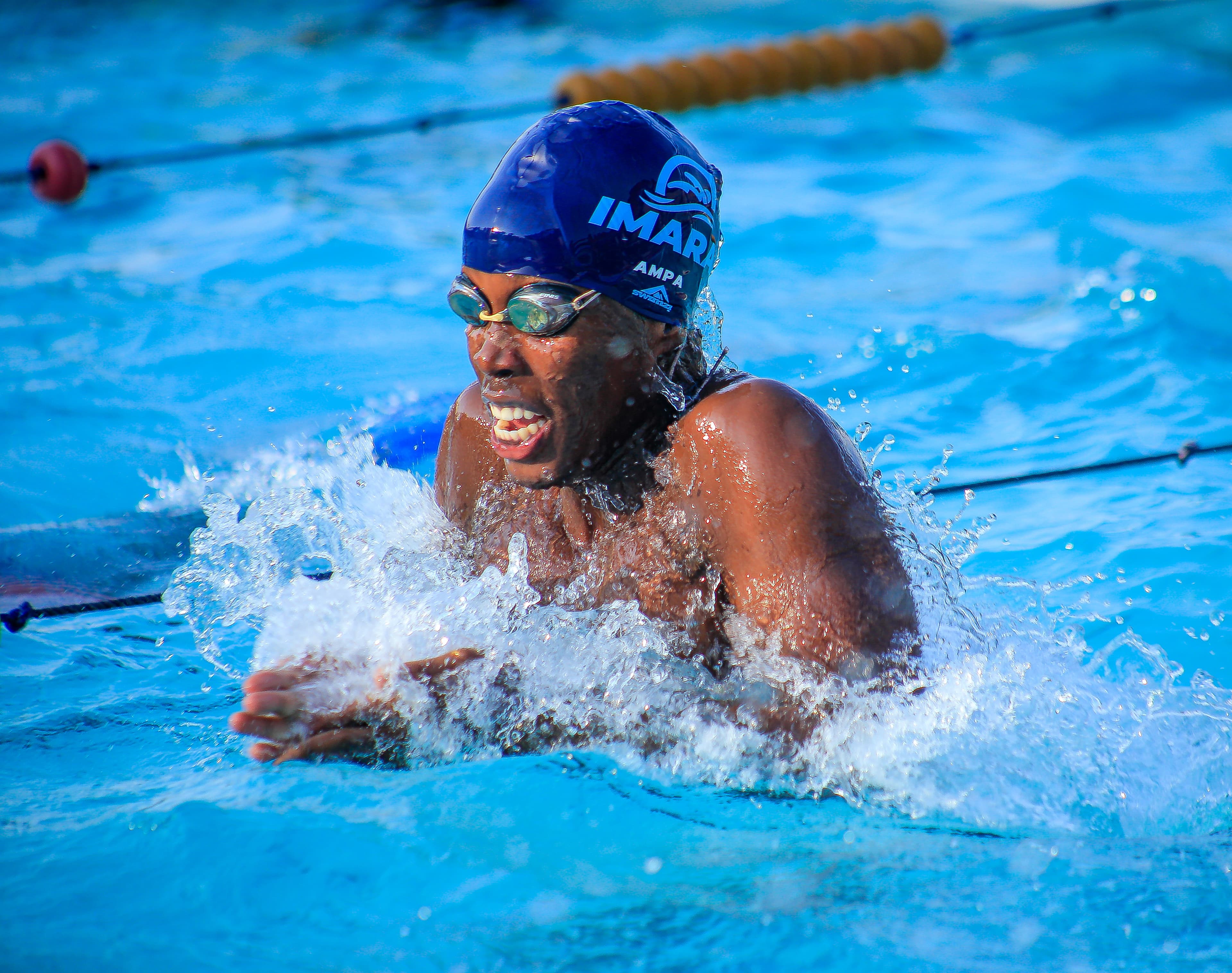 An Imara Aquatics swimmer racing breaststroke in the pool